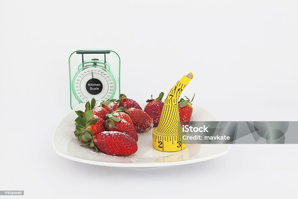 Strawberries in a plate with weight scale Strawberries in a plate with a weight scale isolated on white background Apple - Fruit Stock Photo