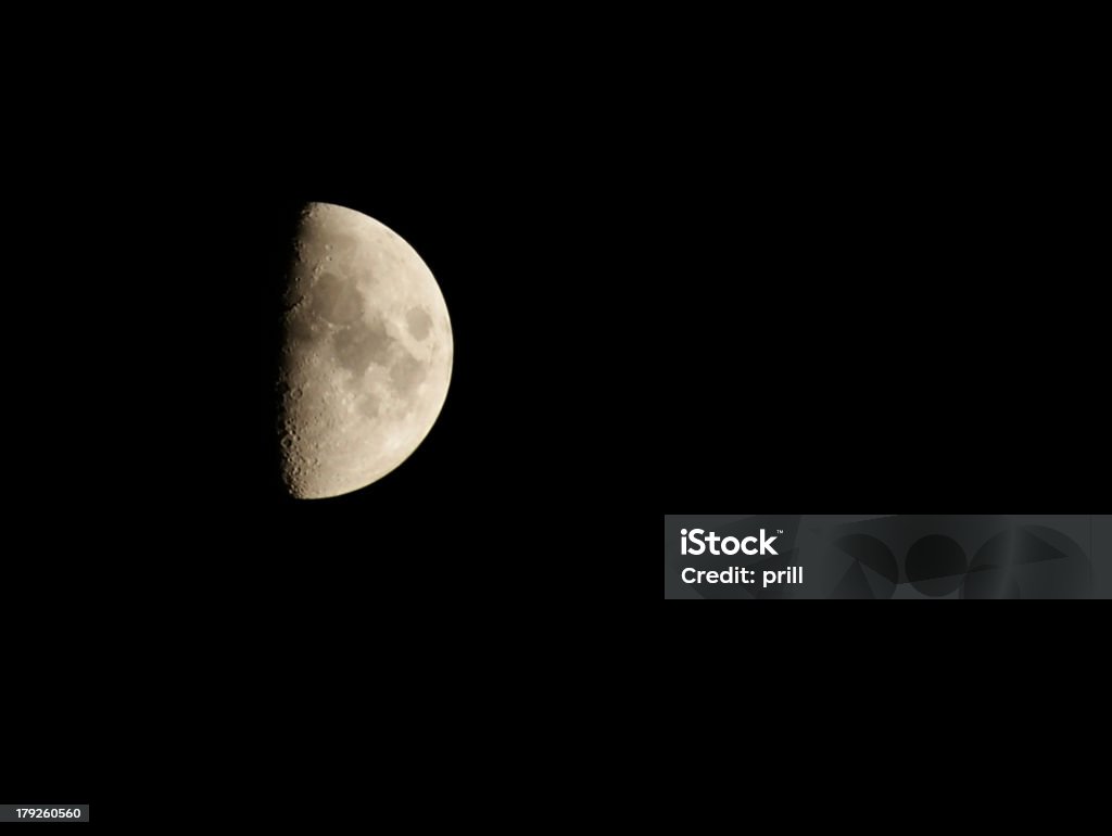 half moon in black back the moon half illuminated at night Abstract Stock Photo