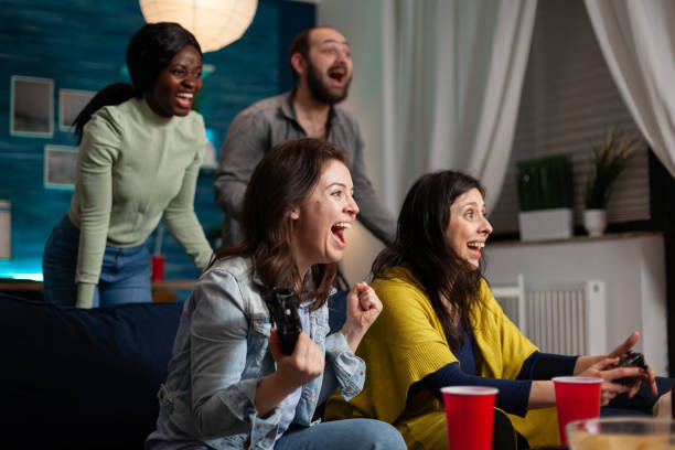 istock Happy multi ethinc friends celebrating victory while playing online video games 1792607163