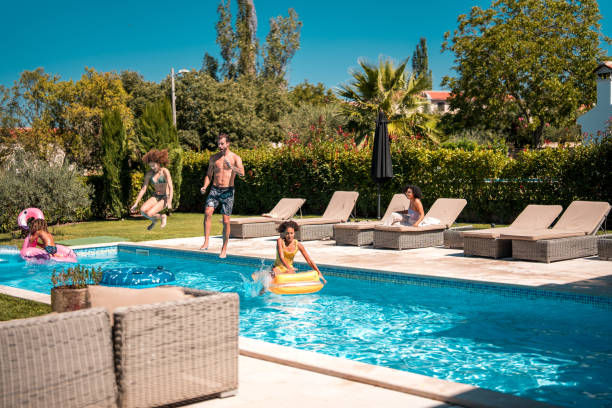 istock Caucasian Dad and Mixed Race Kids Splash and Jump 1792608302