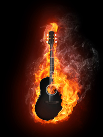 Acoustic - Electric Guitar in Fire Flame Isolated on Black Background