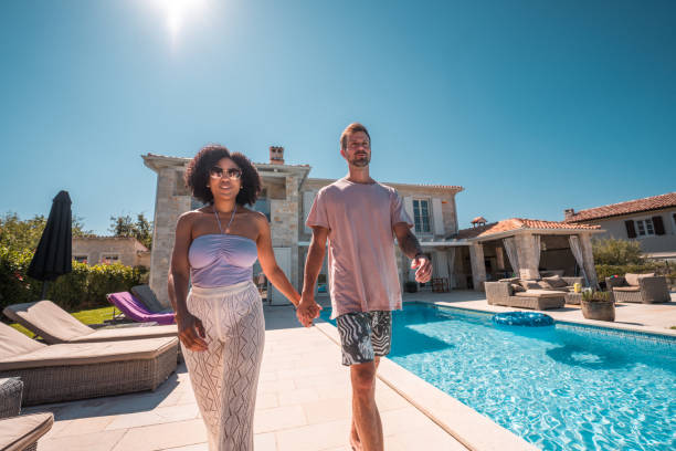 istock Couple's Joyful Hand-in-Hand Moments by the Pool 1792611013