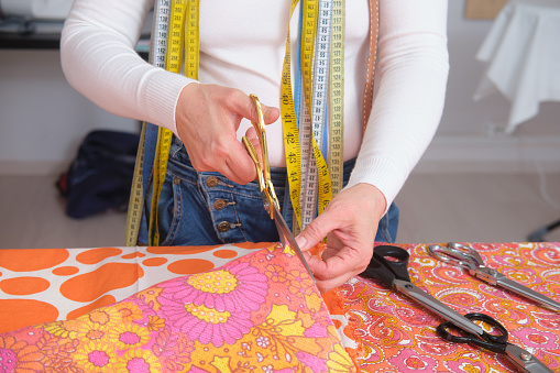 Fashion designer woman working on her designs in the studio. Close-up