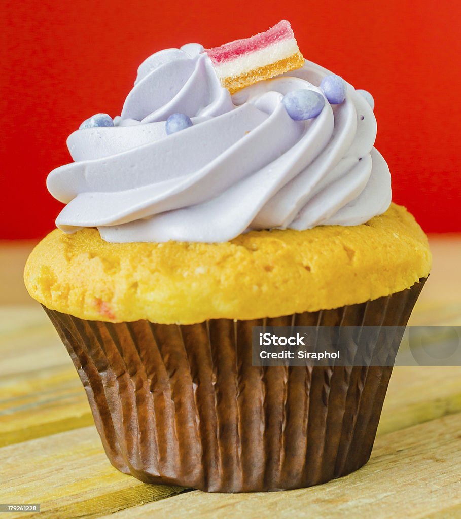 Cupcake Cupcake on the wood table with color backgroundChocolate cupcake with white cup tea Baked Stock Photo