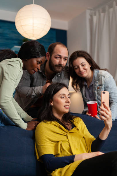 istock Multi ethnic friends bonding and talking on smartphone during video call 1792612774