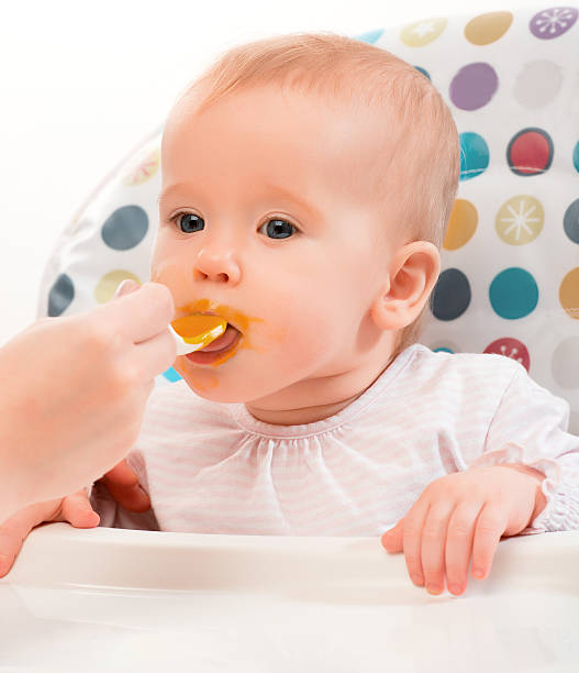 istock Mom feeds funny baby 179261705