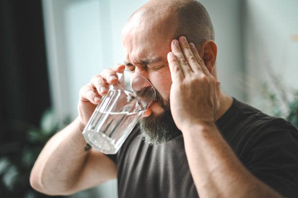 istock man drinking medicine for headache 1792618599