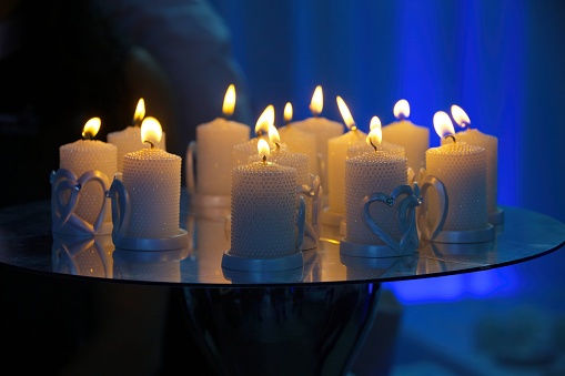 A closeup shot of colorful candles in tin cans