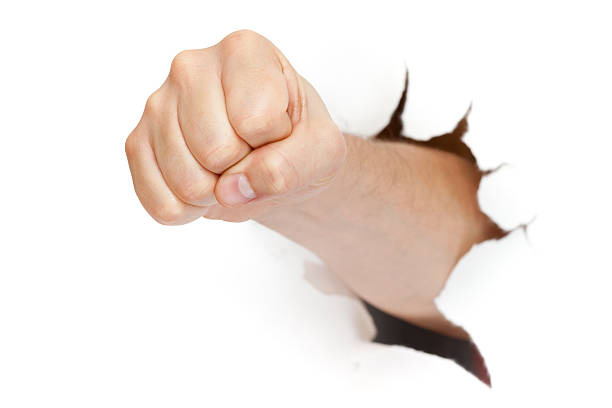 istock fist punching through paper isolated on white background 179262399