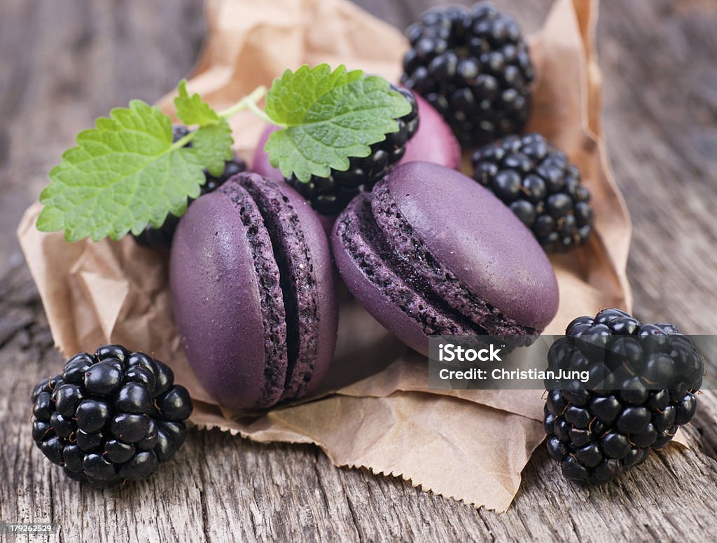 Macaroons with blackberries Macaroons with blackberries on wooden ground Backgrounds Stock Photo