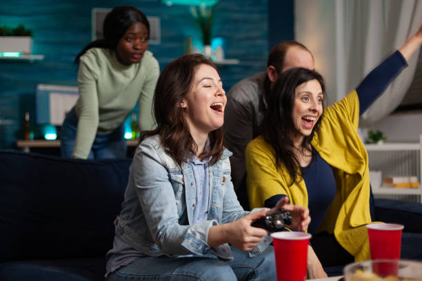 istock Happy excited women playing videogames using gaming controller winning online competition 1792627220