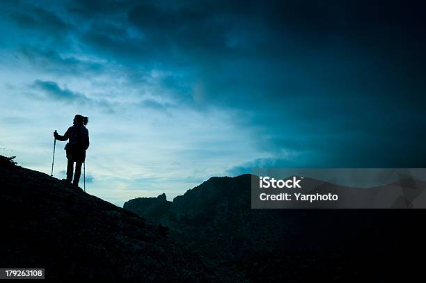 Woman Tracking Sticks Up On The Mountain Stock Photo - Download Image Now - Adult, Adults Only, Adventure