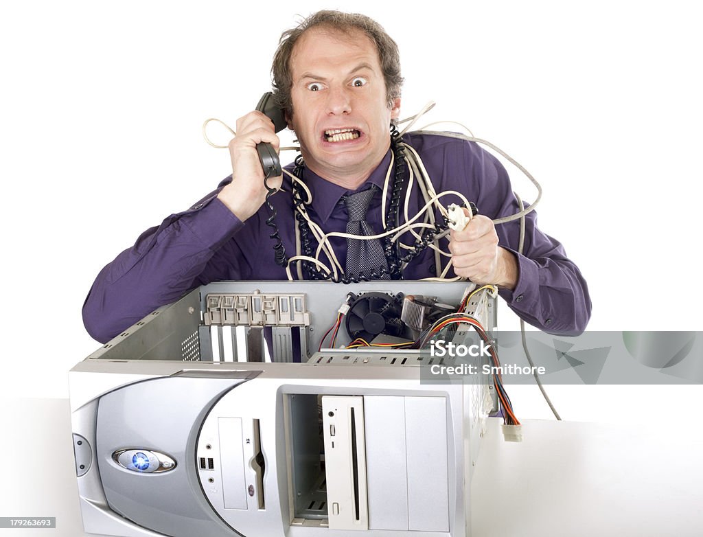 businessman computer problems irritated businessman having computer problems phoning hotline Computer Equipment Stock Photo