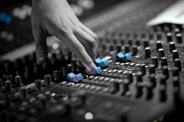 audio mixing One hand making adjustment on an audio soundboard regler stock pictures, royalty-free photos & images