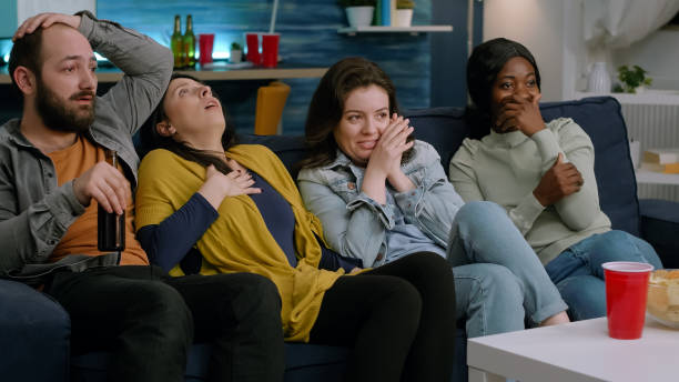 istock Group of multi-ethnic watching at terrifying movie on television 1792641469