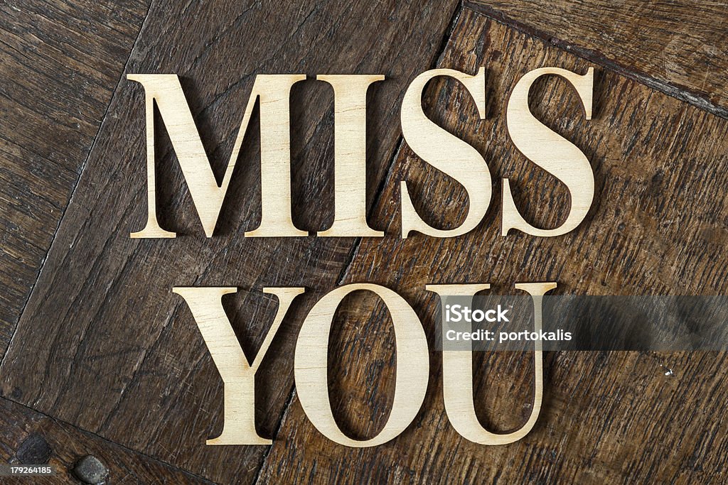 Letters on wooden background Wooden letters forming words MISS YOU written on old vintage wooden plates Abstract Stock Photo