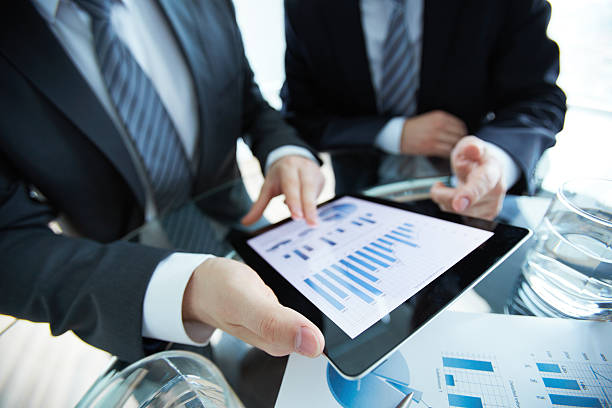 istock Businesspeople looking over a digital tablet 179264206