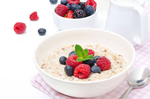 istock healthy breakfast - oatmeal with fresh berries isolated on white 179265214