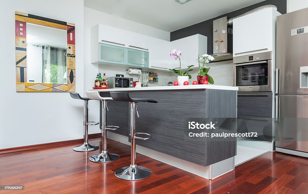 Modern contemporary-style kitchen with fire-tone colors Beautiful modern kitchen in designer house Apartment Stock Photo