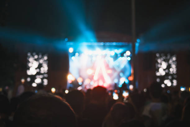 istock Nighttime Outdoor Concert with Blurry Stage Lights 1792658278