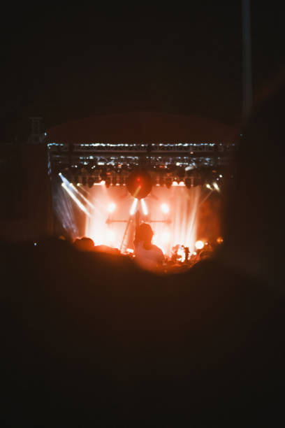 istock Nighttime Outdoor Concert with Blurry Stage Lights 1792658279