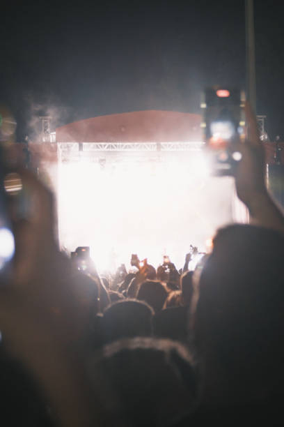 istock Nighttime Outdoor Concert with Blurry Stage Lights 1792658280