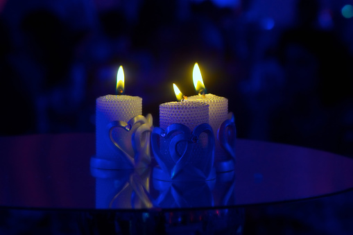 White candles on a blue background