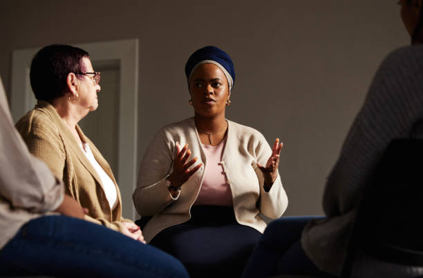 istock Support, black woman and senior group therapy with understanding, feelings and talking in session. Mental health, grief or depression, people in retirement with therapist sitting together for healing 1792660422