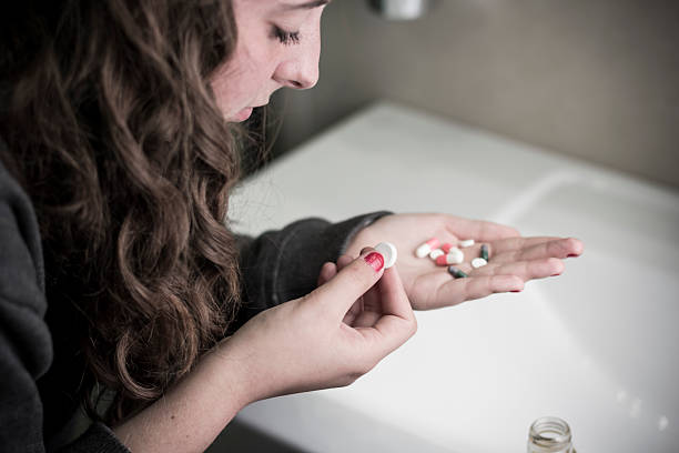 Drug teenage girl Teen girl holding a selection of pills pill prescription capsule prescription medicine stock pictures, royalty-free photos & images