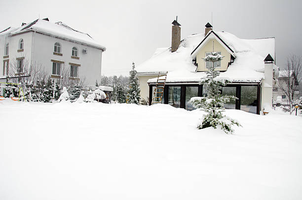 private houses and their gardens under snow in winter