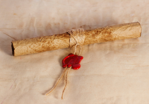 Ancient parchment scroll with wax seal and twine