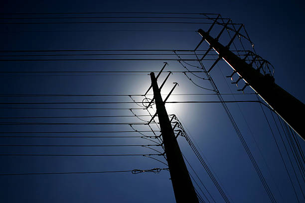 Maze of power lines against deep blue sky Backlit power lines pulsing energy into the Las Vegas strip.  Bzzzzzzzzzt! blackout photos stock pictures, royalty-free photos & images