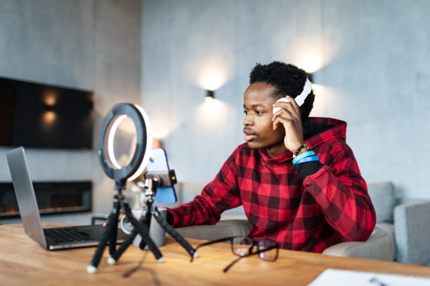 istock Young black man live streaming from home 1792693258