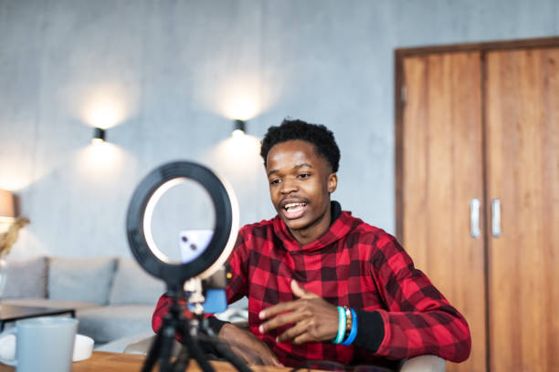 istock Young black man live streaming from home 1792693792