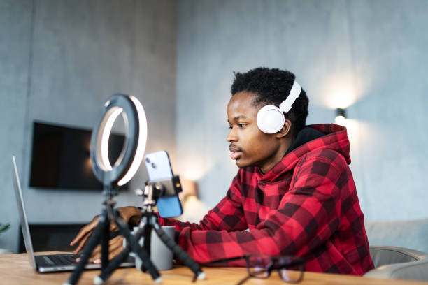 istock Young black man live streaming from home 1792693911