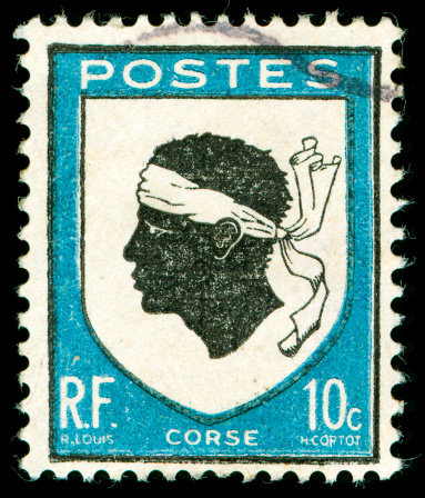 vintage postage stamp with Corsica national emblem of a Moorish head with white bandanna