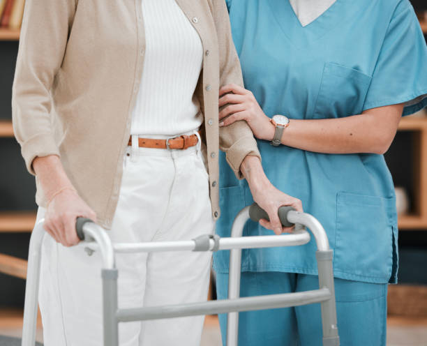 istock Nurse or senior hands on walking frame for support, help or trust moving legs in rehabilitation. Physiotherapy healthcare, elderly nursing or medical caregiver consulting disabled patient 1792694964