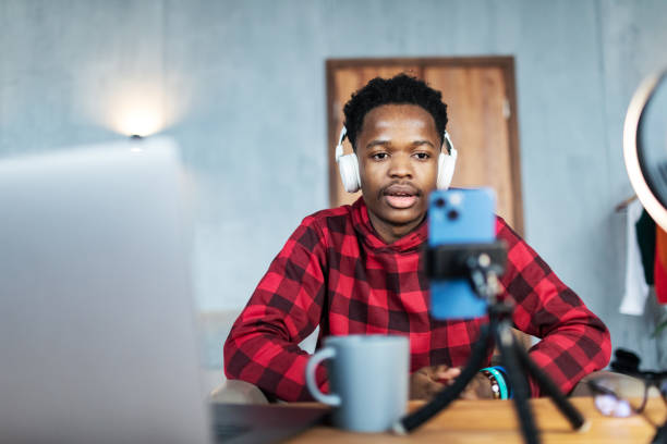 istock Young black man live streaming from home 1792695491