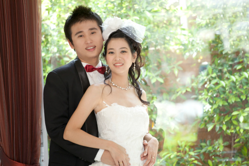 portrait of couples of asian groom and bride in wedding suit