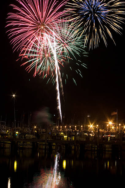 Fireworks on the ocean. Water reflection stock photo