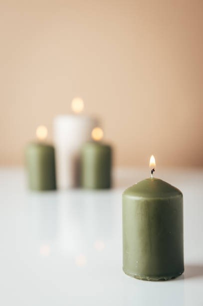istock Burning candles in green and beige colors 1792701972