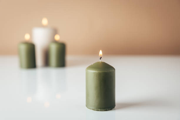 istock Burning candles in green and beige colors 1792701996