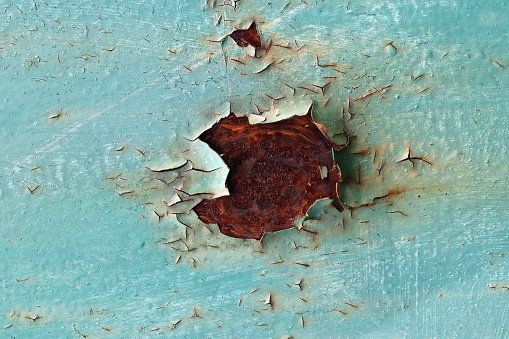 Detail of the flaking paint from the metal surface