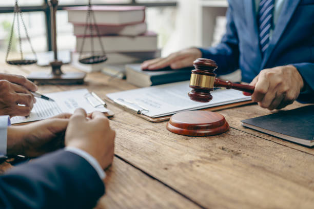 istock Judge giving advice or discussing contract documents with business client in office lawyer working Businesses deal with legal issues in the courtroom to help their clients. 1792702002