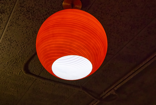 Red lamp and electrical conduit on the ceiling, electrical objects background
