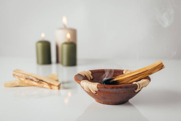 istock Palo santo burning stick with candles in background 1792705330