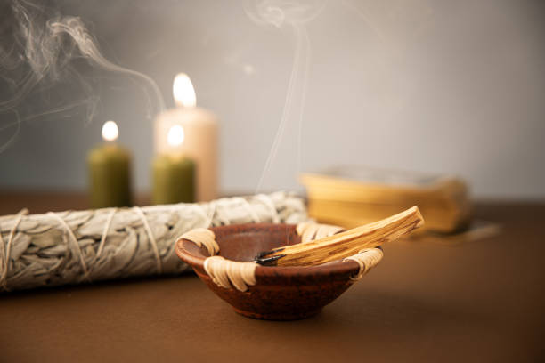 Palo santo burning stick with white sage and tarot deck stock photo