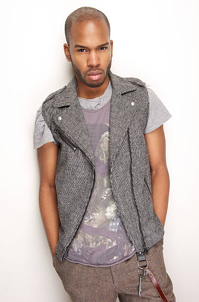 istock Black fashion model leaning against white wall 179271008
