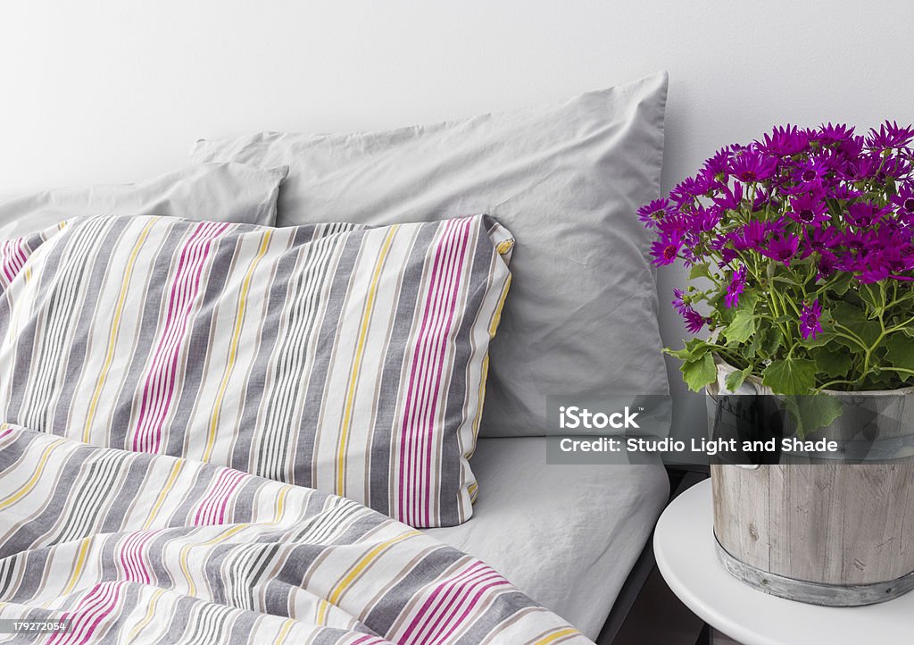 Bedroom decorated with bright purple flowers Modern bedroom decorated with bright purple flowers. Fresh design. Apartment Stock Photo