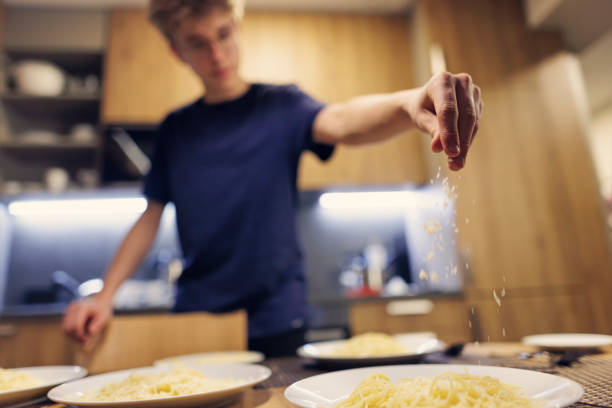 istock Teenagers cooking spaghetti dinner together 1792720737